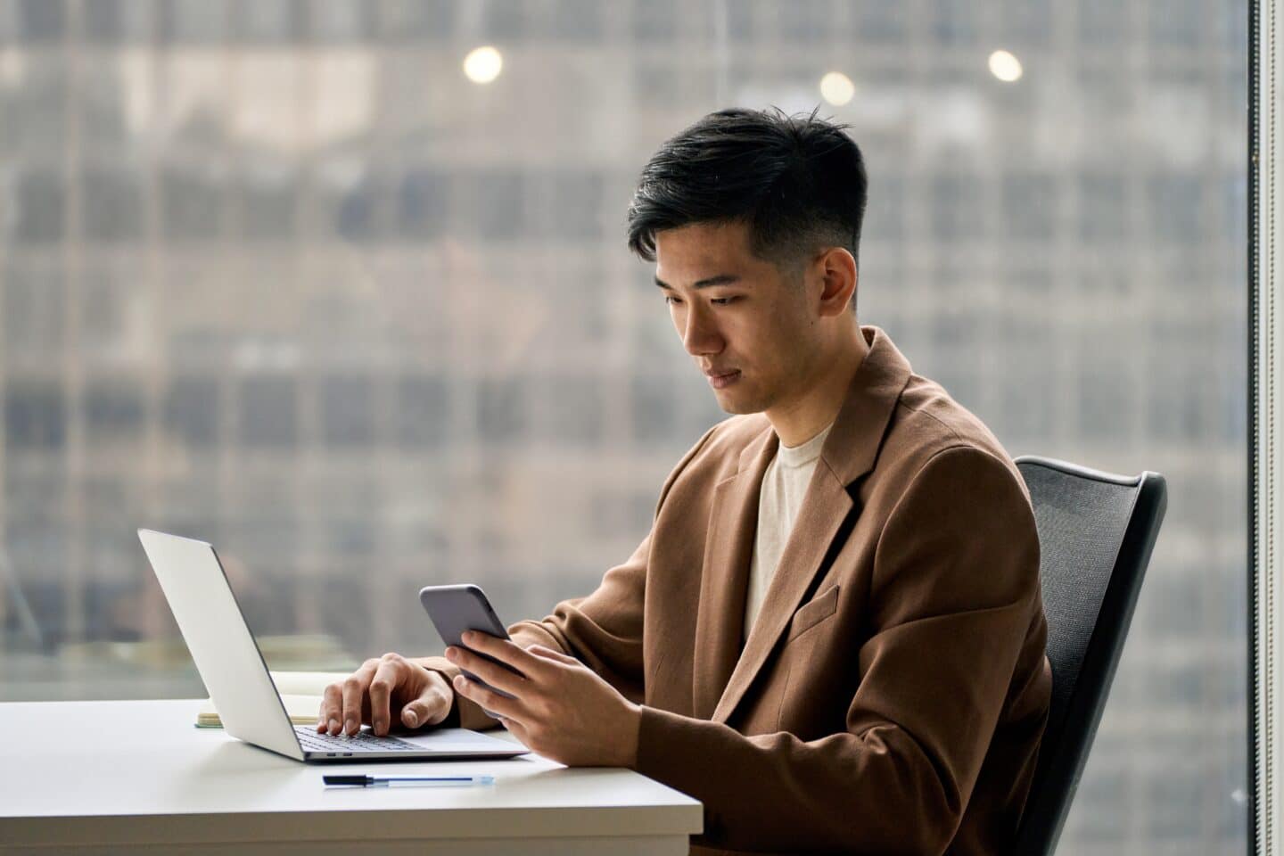 Person sitting at a desk with their laptop busy with therapy for anxiety